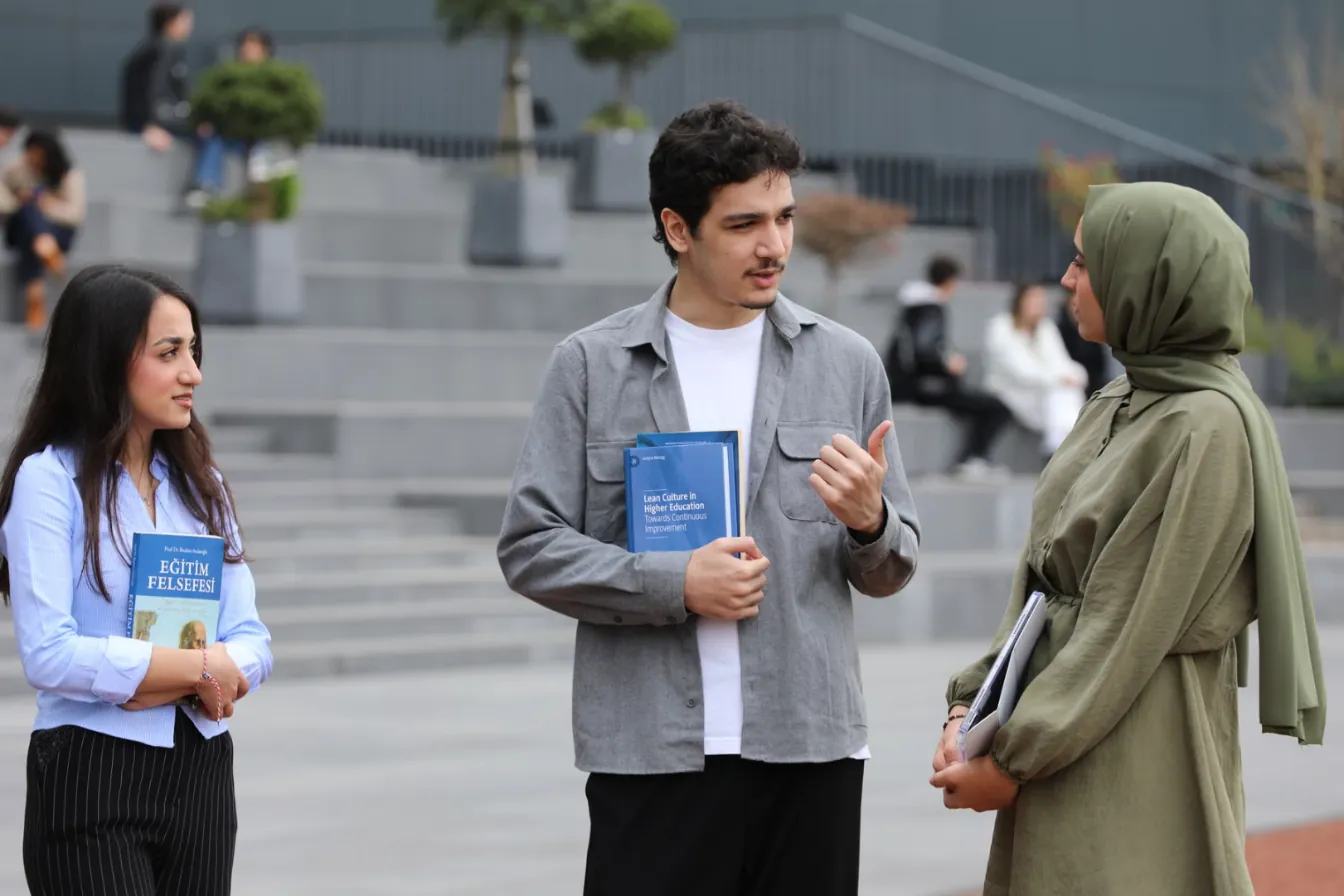 Three university students talking on campus